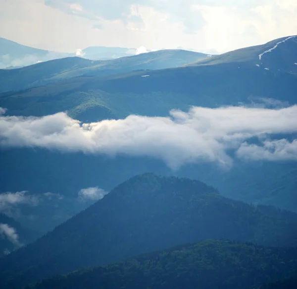 The fog rises over the mountains after the rain in the Carpathians