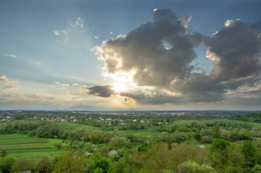 Beautiful summer landscape, sun rays at sunset over the city of Ivano-Frankivsk in Ukraine