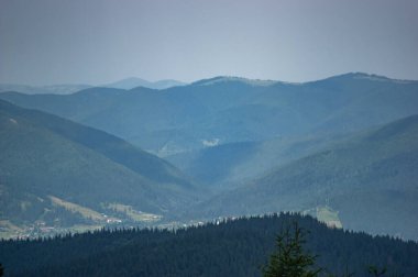 Panorama of a village among the mountains in the Ukrainian carpathians on a summer day