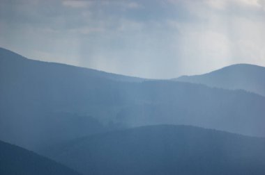 Carpathian mountains and forests in the haze on a summer day, beautiful landscape