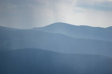 Carpathian mountains and forests in the haze on a summer day, beautiful landscape