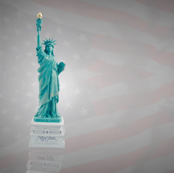 Statue of Liberty on a dark flag of America — Stock Photo, Image