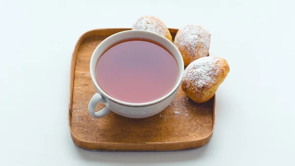 Cup of  tea and three eclair — Stock Photo, Image