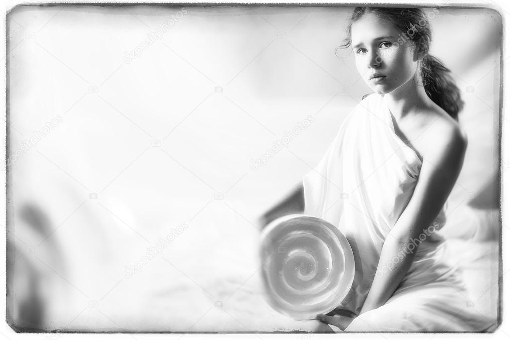 Pretty young girl sitting on the floor and holding a round white vase