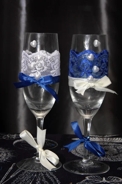 Two glasses decorated with flowers for a wedding reception