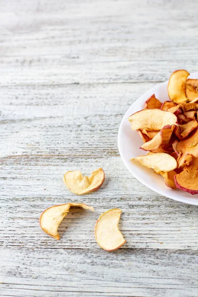 Pile Dried Apples Slices White Plate Wooden Background Dried Fruit — Stock Photo, Image