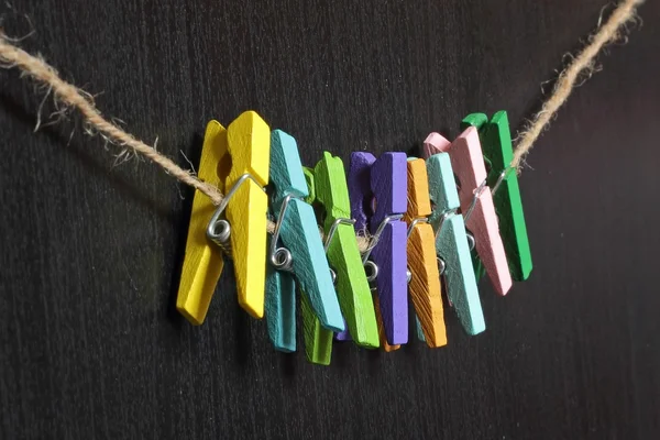 Small colored clothespins on a rope — Stock Photo, Image