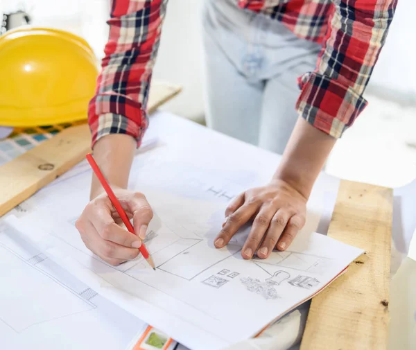 Engineer working alone at construction property site. Architecture with project on blueprint for master plan.