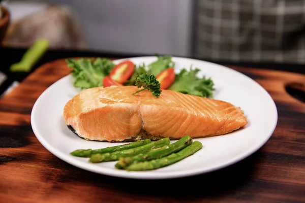 Cooking salmon steak with salad. Homemade fresh fish for healthy and diet food.