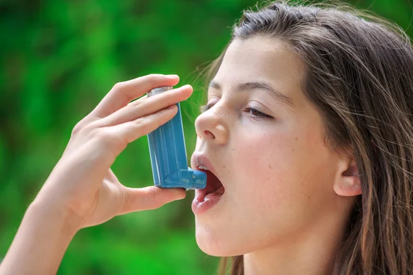 Potret seorang gadis menggunakan inhaler asma — Stok Foto