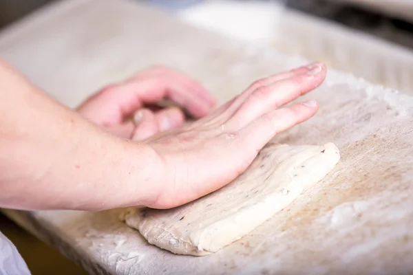 Zbliżenie dłoni piekarz wyrabia i formowanie ciasta — Zdjęcie stockowe