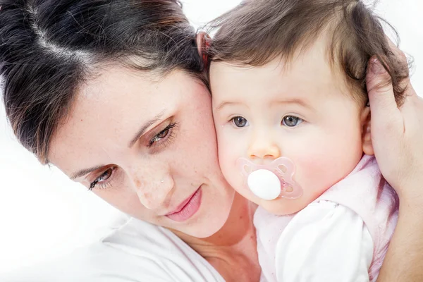 Close-up of a smiling young woman with her baby on white background — Stock Photo, Image