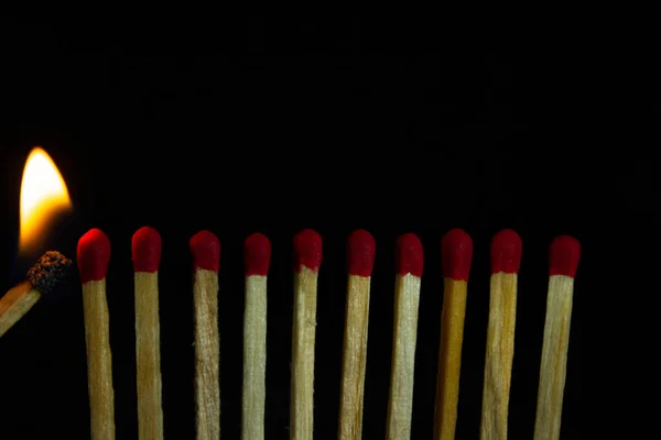 Group of red match burning isolated on black background. Row Burning In Chain Reaction