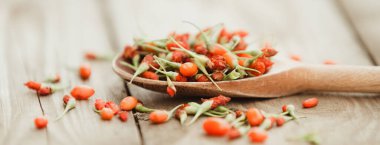 Ahşap arka planda olgun goji üzümleri