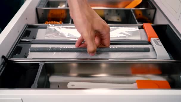 Cortador funcional para filme alimentício também um cortador para folha de alumínio. Gaveta aberta com diferentes utensílios na cozinha. — Vídeo de Stock