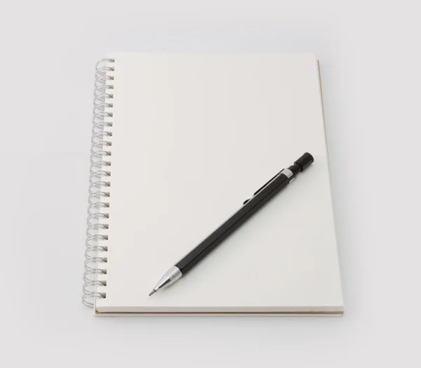 Black mechanicalpencil on blank note book isolated on white. — Stock Photo, Image