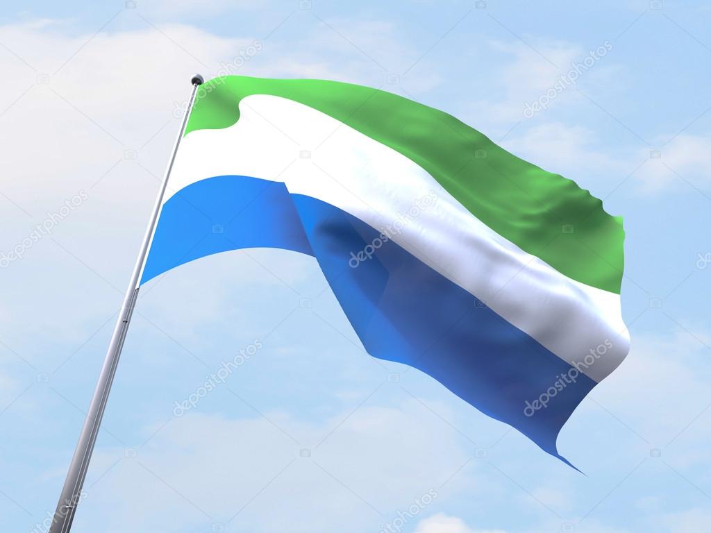 Sierra Leone flag flying on clear sky.