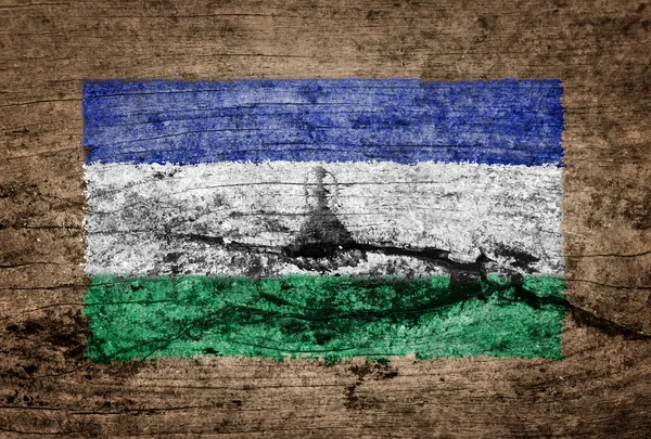 Lesotho Flagge auf Holz Hintergrund gemalt — Stockfoto