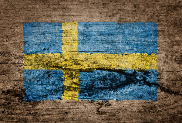 Флаг Швеции на деревянном фоне

