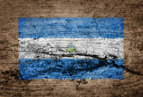 Ahşap arka plan üzerine boyalı Nikaragua bayrağı — Stok fotoğraf