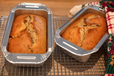 Alüminyum bir tavada pişmiş altın kabuklu muz ekmeği ve Noel sezonu için bayram havlusu.