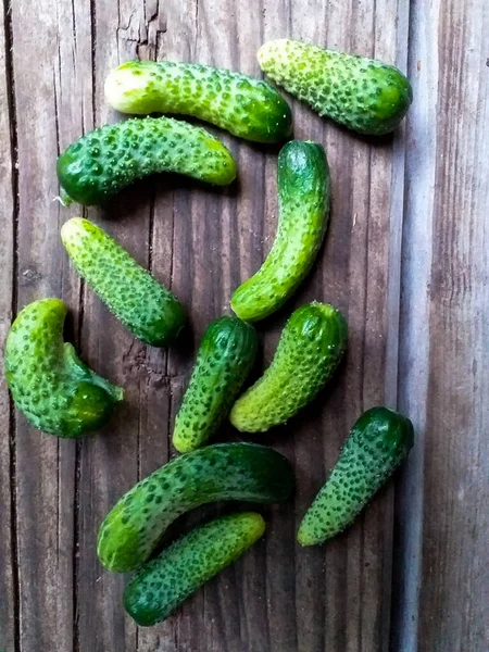Kleine Komkommers Een Doos Een Houten Ondergrond — Stockfoto