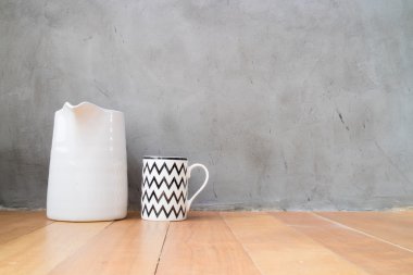 Mug and jar on wood floor