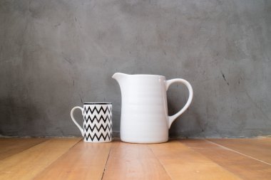 Mug and jar on wood floor