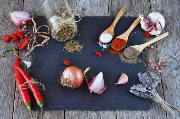 Mixed spices and Condiments  on  the stone, slate and wooden background.