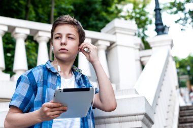 Genç merdivenlerden yakın dururken tablet ile