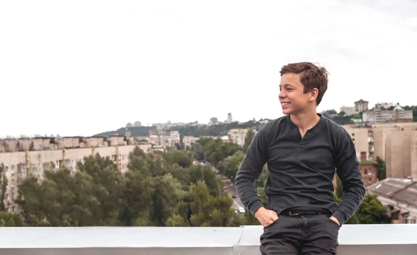 Happy teenager on the roof of the house — Stock Photo, Image