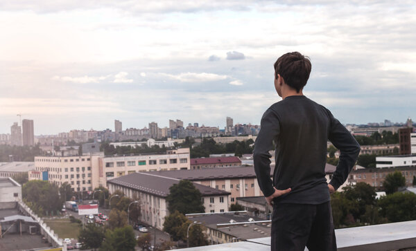 teenager is looking off into the distance while standing on the 