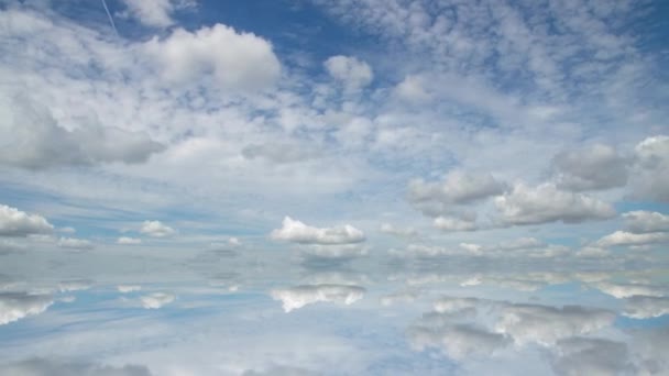 Futuristic background consisting of Time lapse clip of white fluffy clouds over blue sky and their reflection, video loop — Stock Video