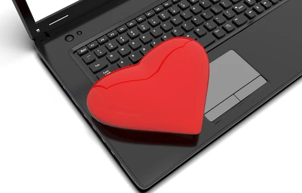 Cuore rosso con un computer portatile — Foto Stock