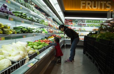 Anne ve kızı süpermarkette ürünler seçme
