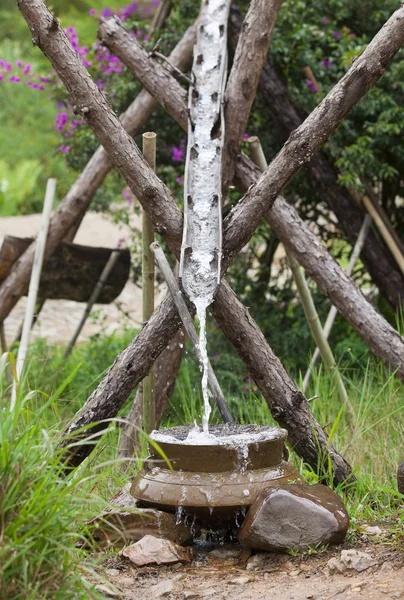 Close up of water flowing into a pot. Wastage of water concept. — Stock Photo, Image