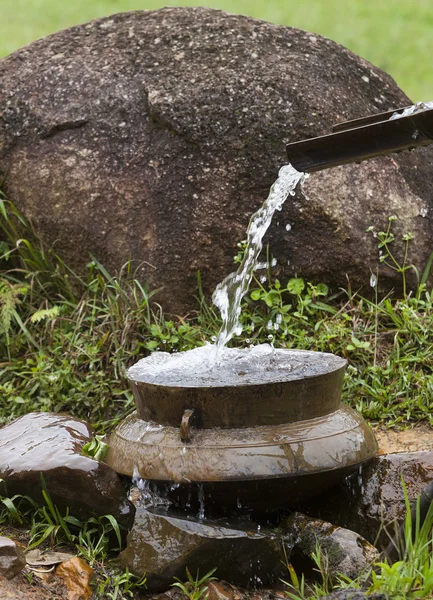 Close up of water flowing into a pot. Wastage of water concept. — Stock Photo, Image