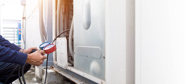 Technician is checking air conditioner ,measuring equipment for filling air conditioners.