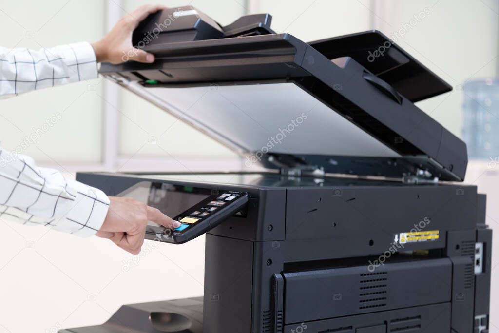 Businessman press button on panel of printer photocopier  network , Working on photocopies in the office concept , printer is office worker tool equipment for scanning and copy paper.