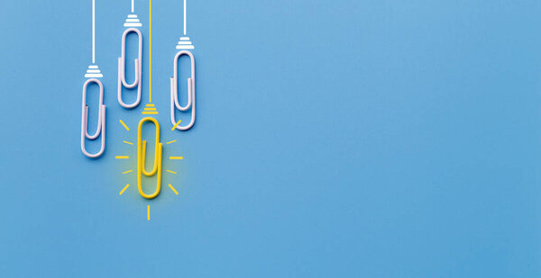 Great ideas concept with paperclip,thinking,creativity,light bulb on blue background,new ideas concept.