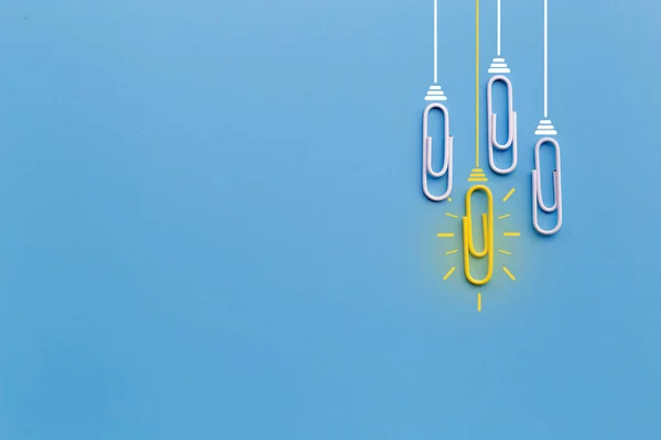 Great ideas concept with paperclip,thinking,creativity,light bulb on blue background,new ideas concept.