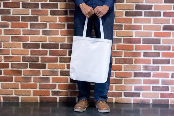 Man holding bag canvas fabric for mockup,ecology concept.
