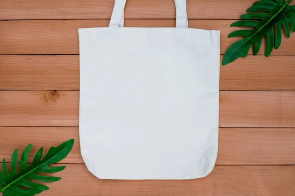 Tote bag canvas fabric cloth shopping sack mockup blank on wood backgroung.