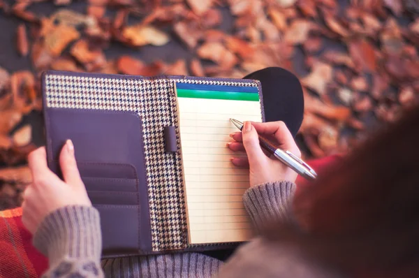 Woman taking notes in a pad