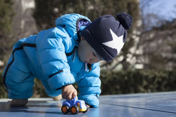 Cute Chinese baby boy playing on a table tennis table — Stock Photo, Image