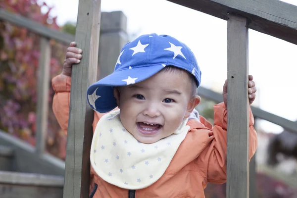 Happy Chinese baby boy playing on stairs outdoors — Stock Photo, Image