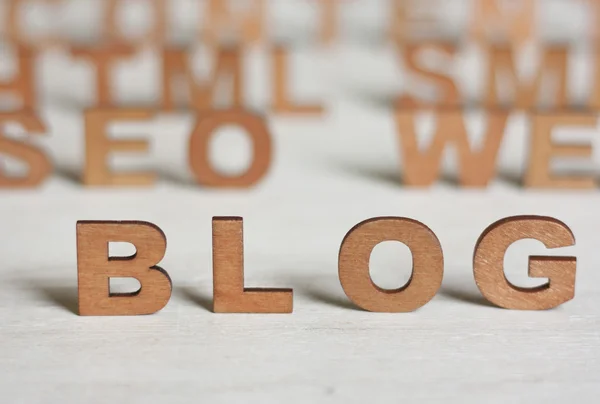 the word blog with wooden letters on a background of blurred let