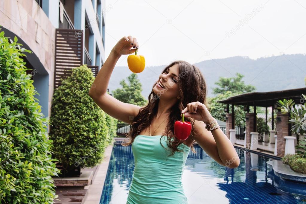 Detox diet: happy beautiful girl with sweet bell peppers