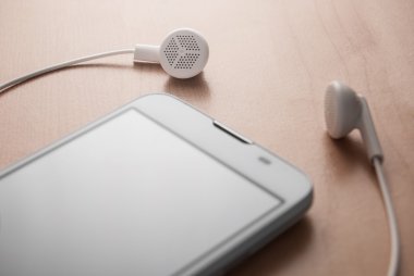 Ahşap arka planda beyaz akıllı telefon