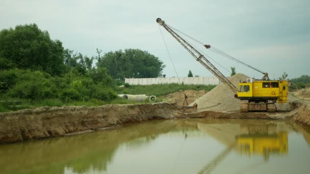 Exploitation minière gravier fosse de sable excavatrice dragueuse dragueuse extraction machine houillère sortie carrière construction grise pile mine grain surface quartz ballast, industrie matériau de construction, trou dévastation nature — Video